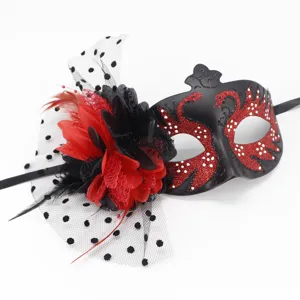 Detailed view of masquerade mask with red flower, mesh veil and glitter swans