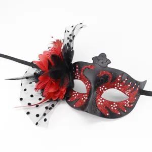 Detailed view of black masquerade mask with red swan glitter and mesh veil detail