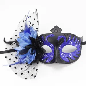 Detail view of the black masquerade mask with blue glitter swans and mesh flower