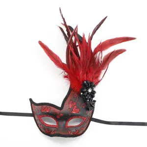 Exquisite masquerade mask with red feathers, glitter patterns, and elegant black ribbons for parties.