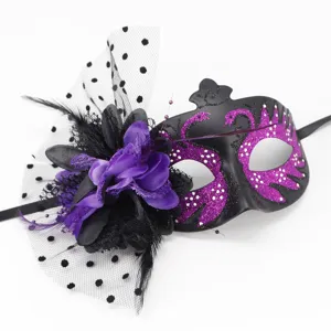 Close-up detail of a purple glitter swan masquerade mask with flower and mesh veil