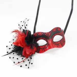 Detailed view of the red and black masquerade mask featuring floral mesh and feather accents.