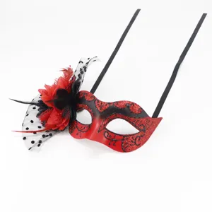 Masquerade mask detail, red and black glitter design with mesh lace flower and feather.