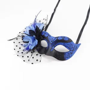 Masquerade mask with blue flowers feathers mesh and black ribbons for Halloween party decor detail view.