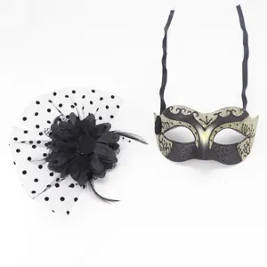 Detailed view of black mesh flower hairpin and gold-patterned masquerade mask for party.