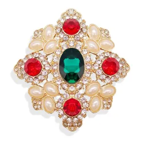 Vintage baroque rhinestone brooch with emerald green and red gems, elegant suit accessory.