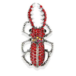 Close-up detail of the vintage stag beetle brooch featuring red rhinestones and silver alloy.