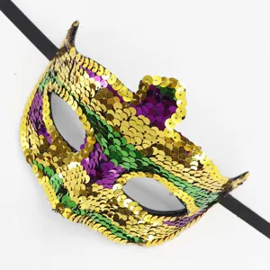 Detaillierte Nahaufnahme einer glitzernden Karnevalsmaske mit Pailletten in Gold, Grün und Violett.