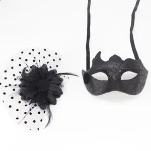 Close-up detail of black masquerade mask and polka dot mesh flower hair accessory set