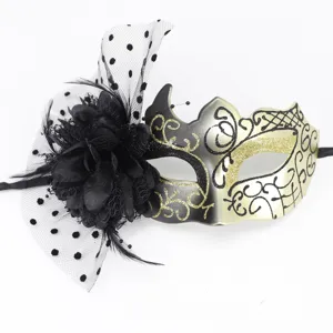 Detailed view of elegant black and gold masquerade mask with flower and mesh veil