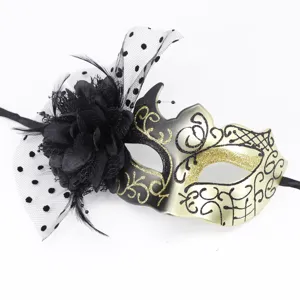 Elegant black gold masquerade mask with large silk flower, mesh veil and feather details.