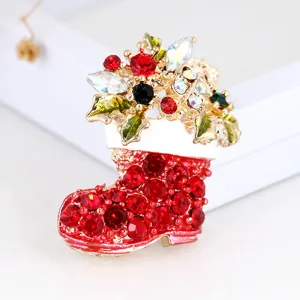 Crystal rhinestone Christmas boot brooch detail close-up, shiny holiday jewelry accessory.