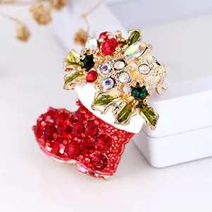 Detailed shot of Christmas boot crystal rhinestone brooch, sparkling holiday jewelry accessory.