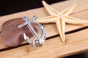 Silver-tone anchor brooch featuring sparkling rhinestones and elegant pearls for women.