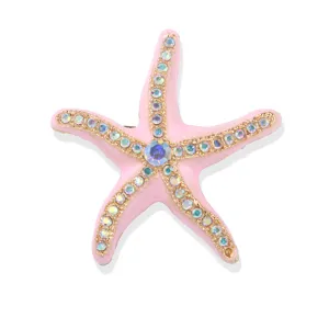 Exquisite pink enamel starfish brooch detailed with sparkling rhinestones and elegant gold trim.