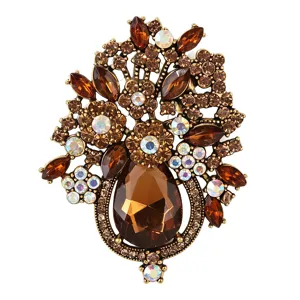Detailed shot of vintage crystal flower brooch, bronze tone alloy with brown rhinestones.