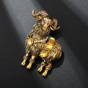 Detailed view of vintage gold tone alloy ram brooch adorned with sparkling yellow rhinestones.