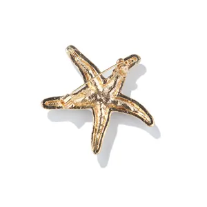 Gold tone starfish brooch detail back view, elegant metal pin for stylish daily wear.