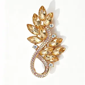 Close-up of luxury gold-toned rhinestone brooch, sparkling crystal details and exquisite metalwork.