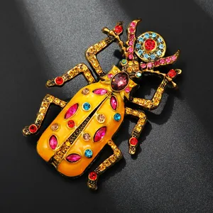 Close-up of vintage alloy enamel rhinestone beetle brooch, detailed metallic texture and vibrant crystal gems.
