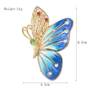Magnifique broche papillon dorée avec émail bleu perles et strass brillants détail.