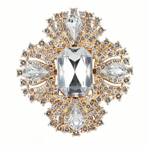 Detailed shot of luxurious gold-tone rhinestone crystal vintage brooch ornate jewelry accessory.