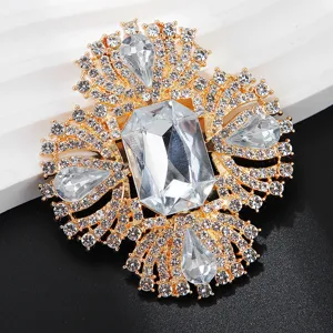 Detailed view of a luxurious gold-tone rhinestone brooch, sparkling crystal floral accessory.