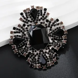 Exquisite black crystal rhinestone luxury brooch detail close-up for elegant clothing accessory.