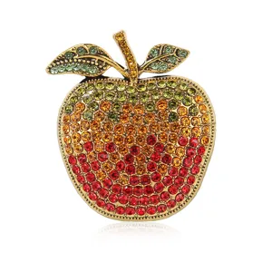 Detail close-up of the exquisite gradient rhinestone apple brooch, showcasing delicate gem details.
