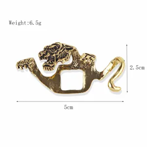 Close-up detail shot of vintage gold tiger brooch featuring intricate engraved lines and textures.