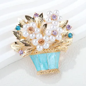 Gold-tone pearl flower basket brooch, rhinestone accented plant pin, fashion jewelry detail.