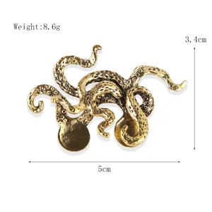 Vintage gold-toned octopus brooch accessory, detailed animal design for suits and coats.