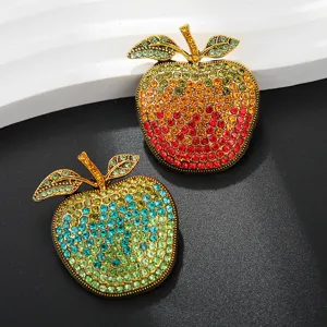 Rhinestone apple brooch detail, sparkling crystal fruit pin for coat and dress decoration.