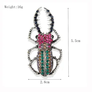 Vintage crystal beetle brooch pin with colorful rhinestones, elegant coat lapel accessory.