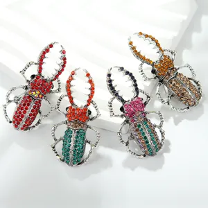 Close-up detail shot of exquisite rhinestone beetle brooches with colorful crystals.