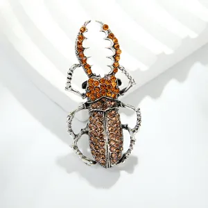 Vintage crystal beetle brooch pin for women, shiny rhinestone insect lapel accessory detail shot.