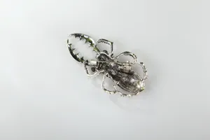 Vintage silver tone stag beetle brooch detail, alloy insect pin back view structure.