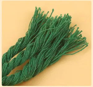 Green cotton rope toy detail close up showing braided texture and durable fibers for pets.