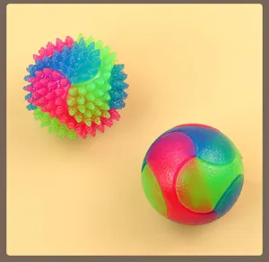Close-up detail of colorful TPR flashing dog toys and interactive bouncy balls for pets.