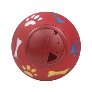 Red interactive dog treat ball, durable rubber chew toy with fun paw and bone designs for pets.