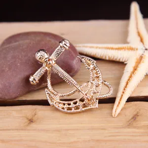 Golden anchor brooch for women, elegant metallic fashion accessory, marine style clothing pin.