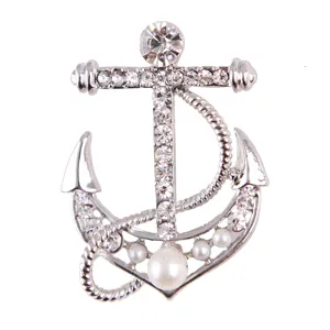 Silver tone anchor brooch featuring sparkling rhinestones and elegant white faux pearls.