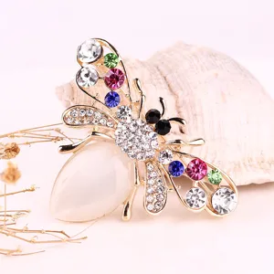 Elegant rhinestone opal bee brooch pin featuring colorful crystals and gold-tone metal.