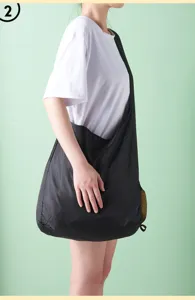 Detail shot of the large black nylon foldable shopping bag worn on shoulder, durable and portable.