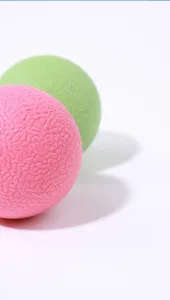 Detailed close-up view of colorful rubber pet elastic balls with textured surface.