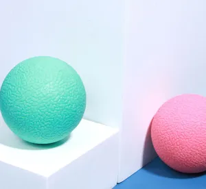Detailed close up view of textured rubber pet bouncy ball, vibrant mint green toy for dogs.
