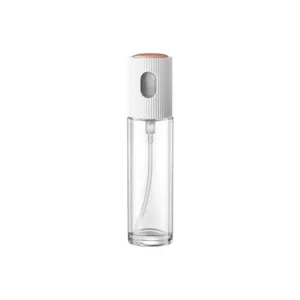 Bottiglia spray per olio da cucina in vetro, dispenser trasparente e design bianco.
