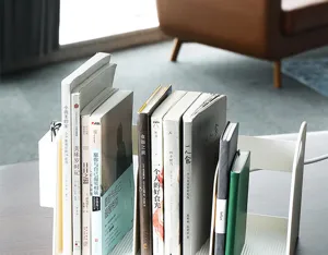Detailed view of the white desktop book organizer with three compartments and pen holder.