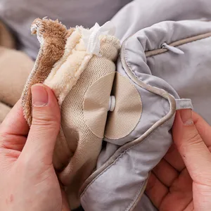 Snap-on duvet cover fastener, plush quilt holder for bedding and sofa cushions securely.