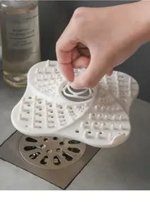 Detail view of the silicone floor drain hair catcher demonstrating its flexible mesh design.